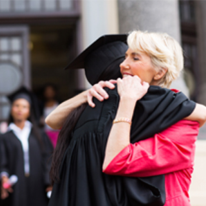 College graduate hugging her mother