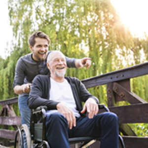 Son pushes elderly father in wheelchair