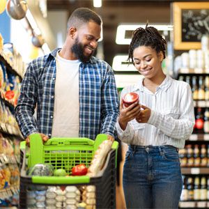 Couple grocery shopping together